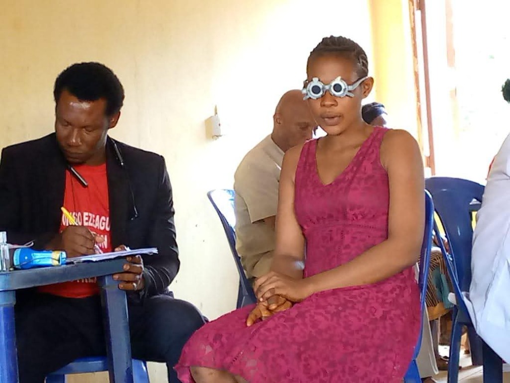 Eye examination during free medical outreach in Achina